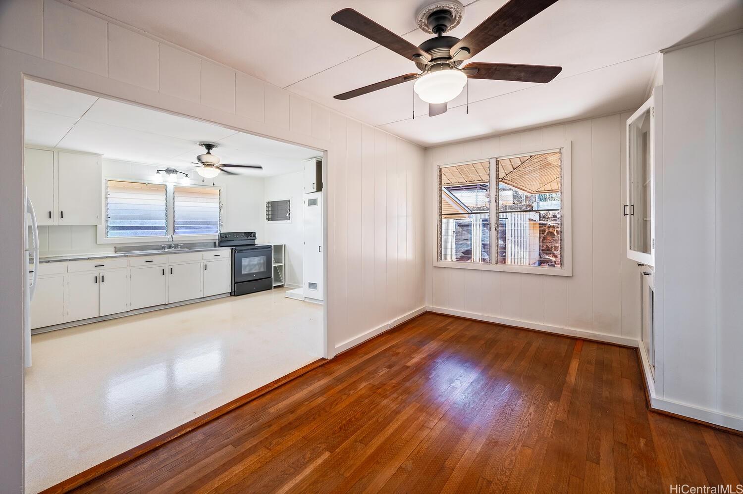930 16th Avenue Honolulu, HI 96816 - Photo 8 of 24 a view of a kitchen with wooden floor and a ceiling fan