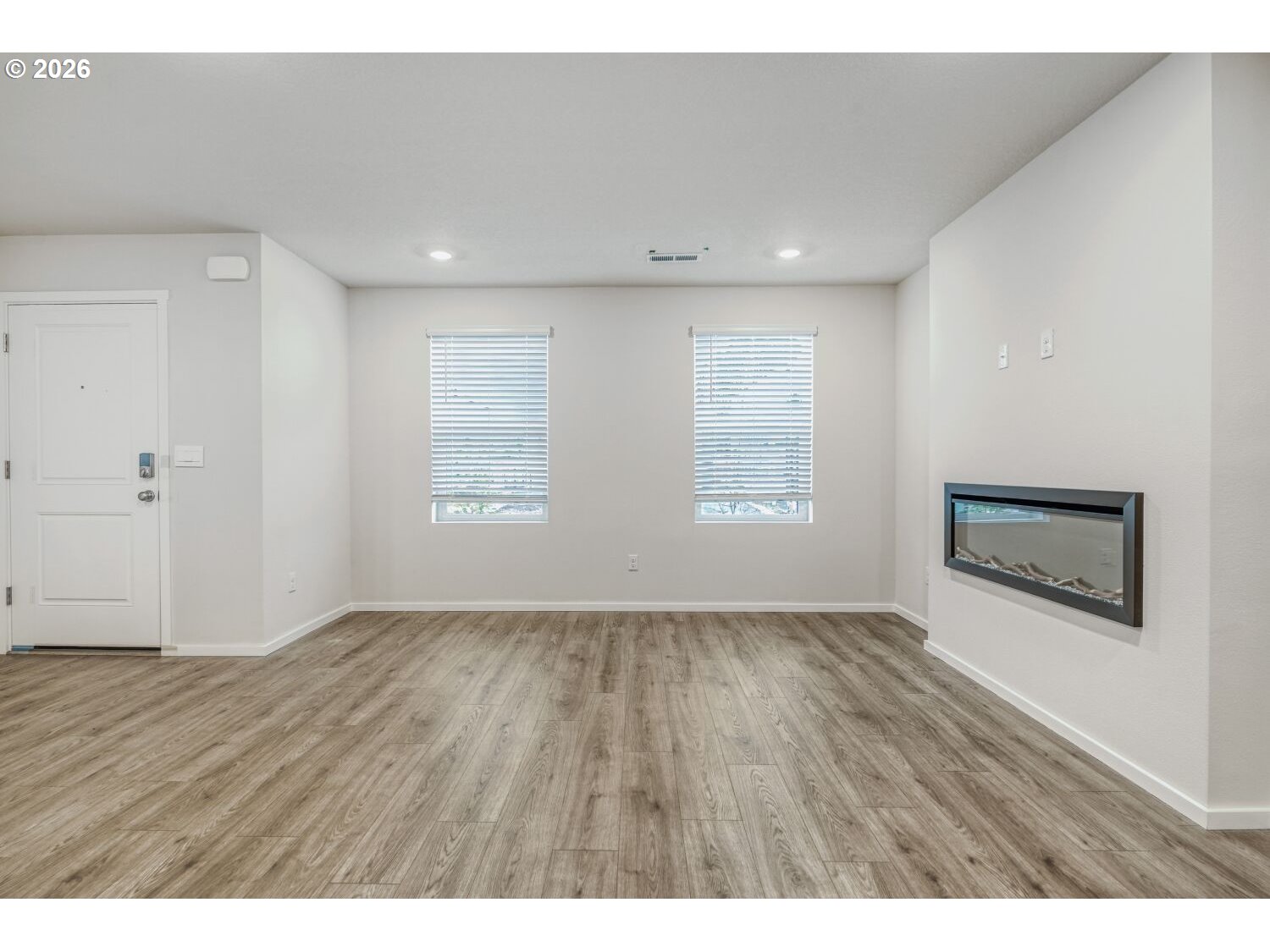 1109 Southeast 193rd Place Camas, WA 98607 - Photo 9 of 29 a view of an empty room with wooden floor and a window