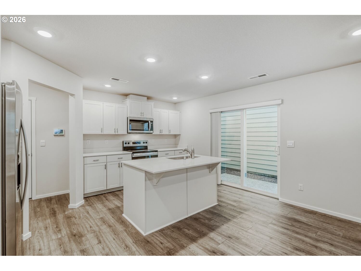1109 Southeast 193rd Place Camas, WA 98607 - Photo 10 of 29 a kitchen with a stove a sink and a refrigerator