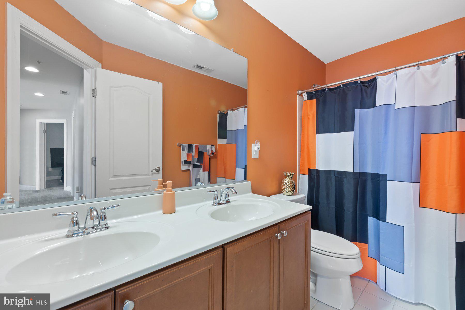 6 Cedar Grove Court Baltimore, MD 21237 - Photo 26 of 50 a bathroom with a granite countertop sink toilet and mirror