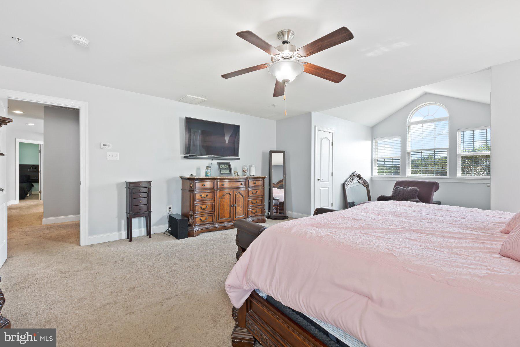 6 Cedar Grove Court Baltimore, MD 21237 - Photo 32 of 50 a bed room with a bed a television and dresser