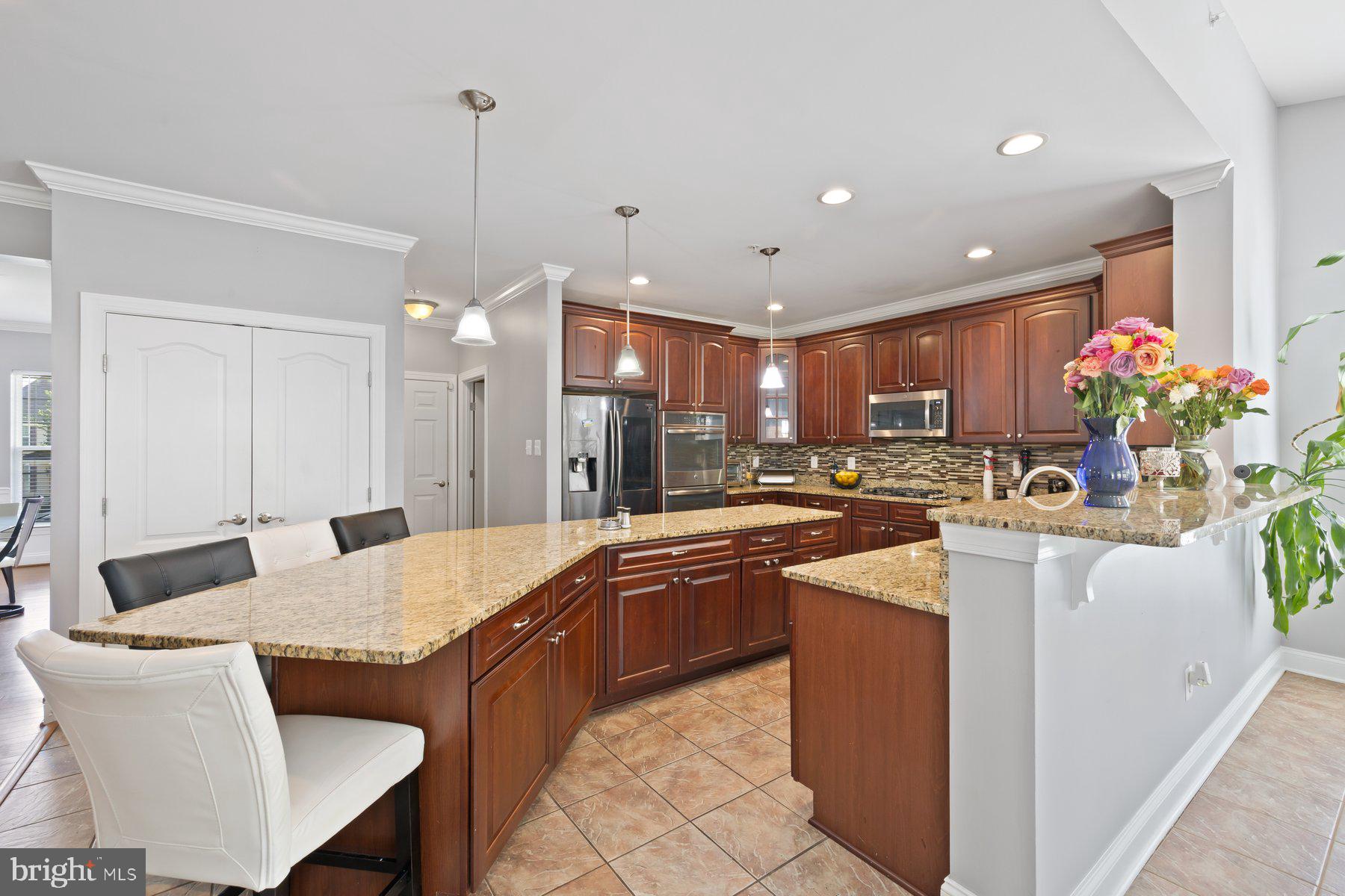 6 Cedar Grove Court Baltimore, MD 21237 - Photo 5 of 50 a large kitchen with kitchen island a sink and a refrigerator