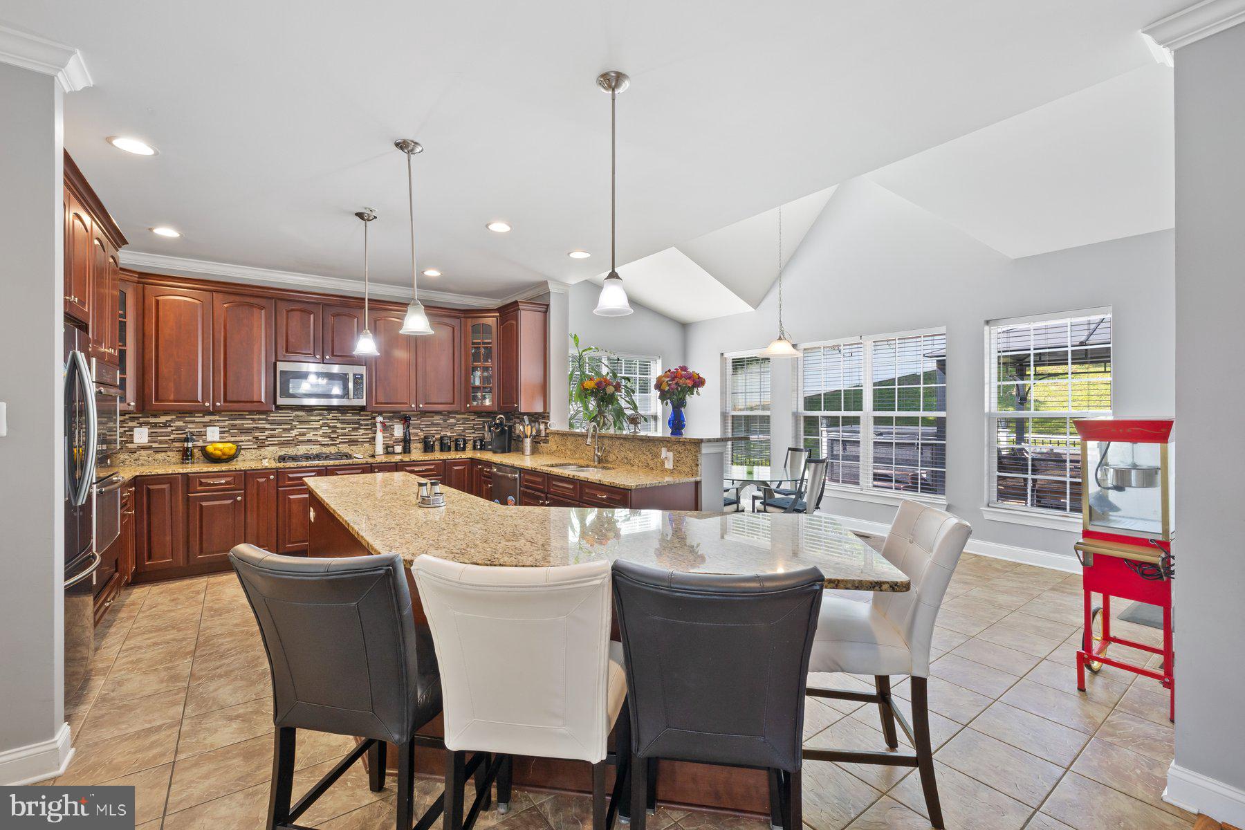 6 Cedar Grove Court Baltimore, MD 21237 - Photo 6 of 50 a dining room with stainless steel appliances kitchen island granite countertop a stove a kitchen island a dining table and chairs