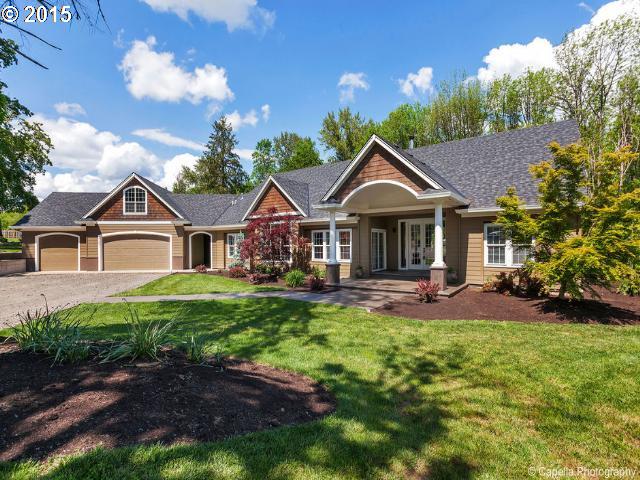 a front view of a house with yard and green space