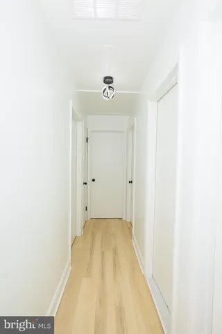 a view of a bedroom with wooden floor and chair