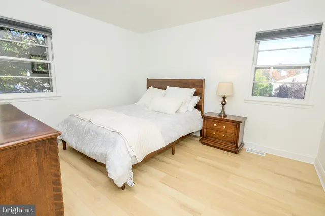 a bedroom with a bed and a night stand