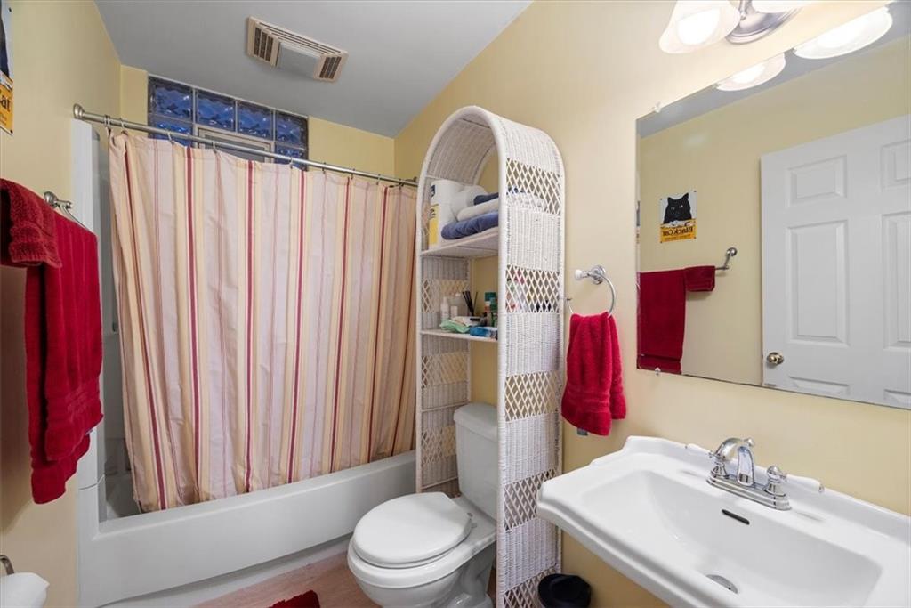 1232 Resaca Place Pittsburgh, PA 15212 - Photo 24 of 44 a bathroom with a sink vanity mirror and toilet