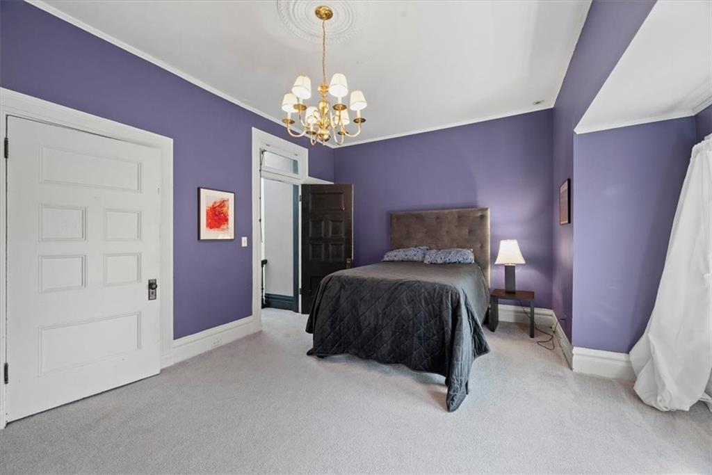 1232 Resaca Place Pittsburgh, PA 15212 - Photo 38 of 44 a bedroom with a bed and a chandelier