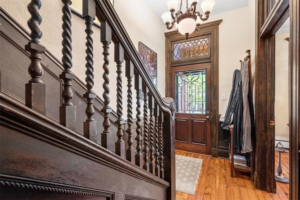 1232 Resaca Place Pittsburgh, PA 15212 - Photo 7 of 44 a view of staircase with lots of frames on wall and a chandelier