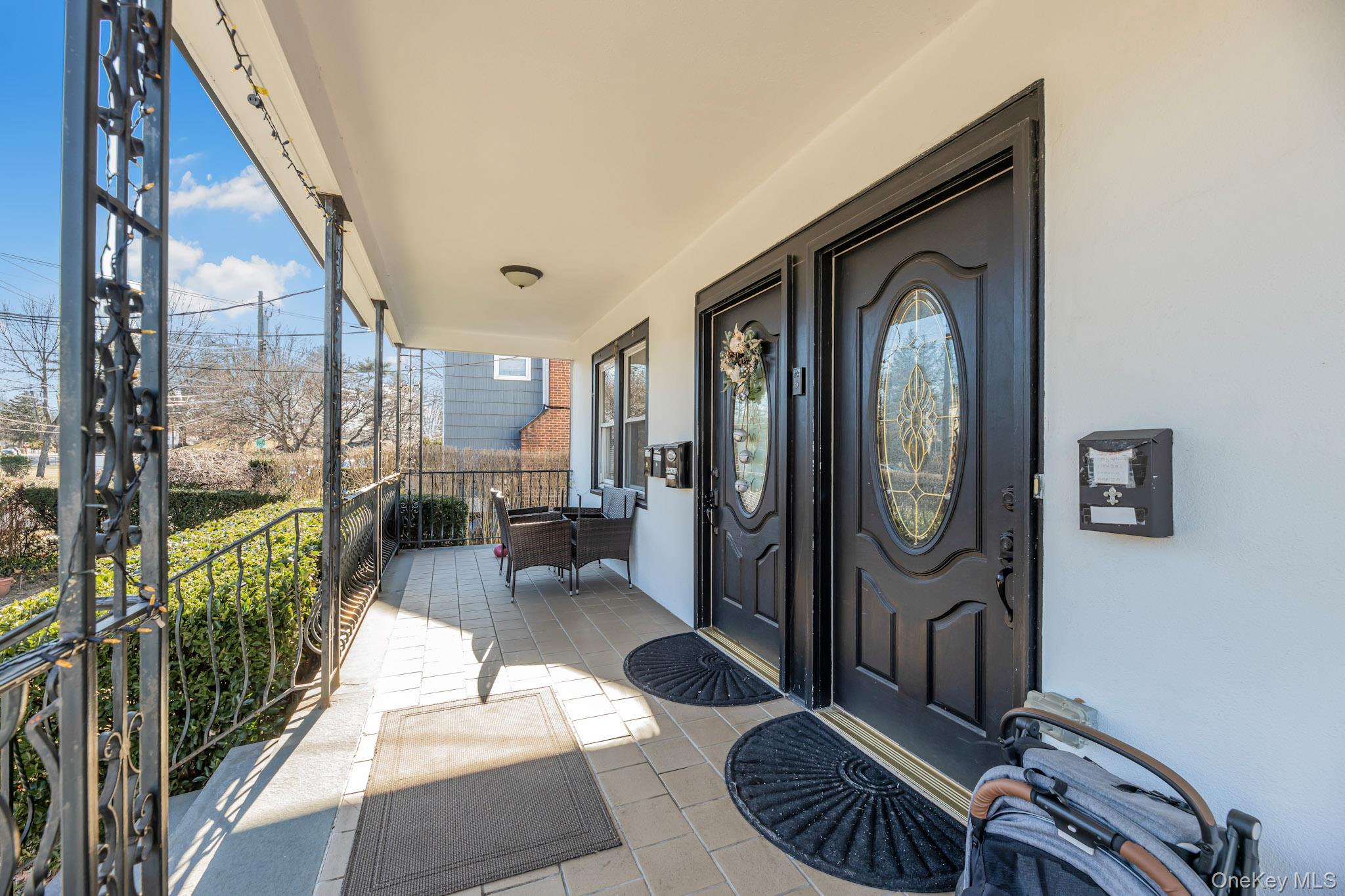 168 Stephenson Boulevard New Rochelle, NY 10801 - Photo 4 of 21 Doorway to property featuring a porch and stucco siding