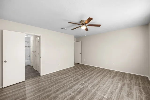 a bathroom with a granite countertop sink a toilet and shower