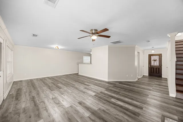 wooden floor in an empty room with a window