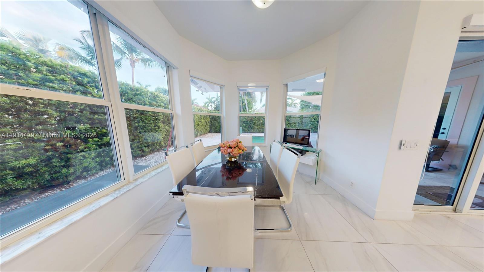 1946 Harbor View Circle Weston, FL 33327 - Photo 11 of 26 a living room with patio furniture and a large window