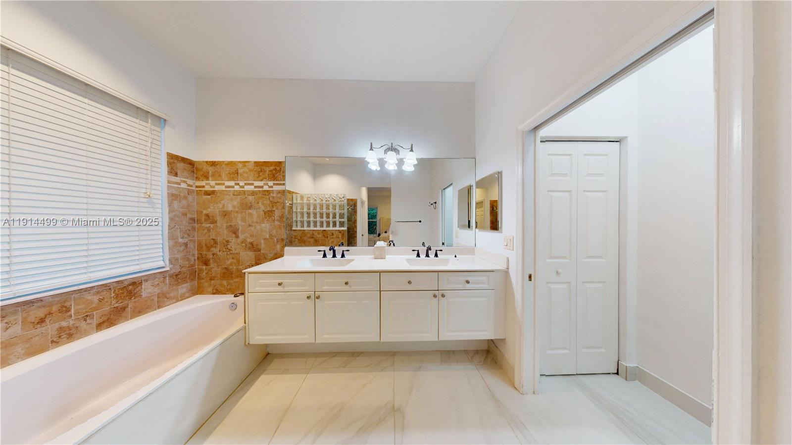 1946 Harbor View Circle Weston, FL 33327 - Photo 18 of 26 a spacious bathroom with a tub sink and mirror