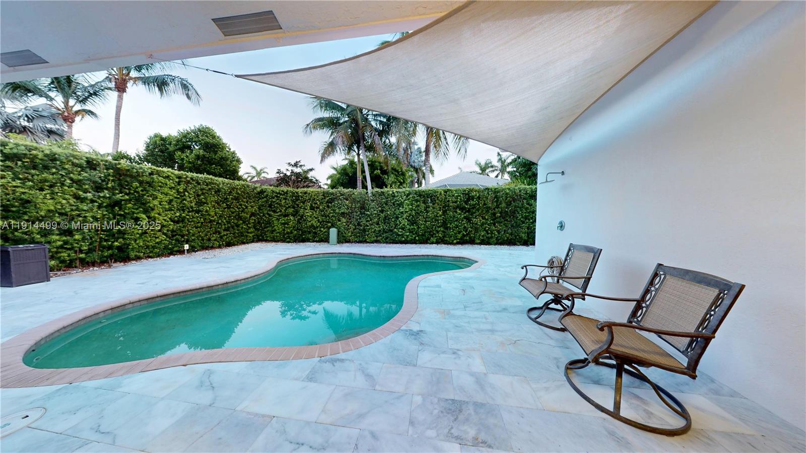 1946 Harbor View Circle Weston, FL 33327 - Photo 7 of 26 a view of a swimming pool with chair and potted plants