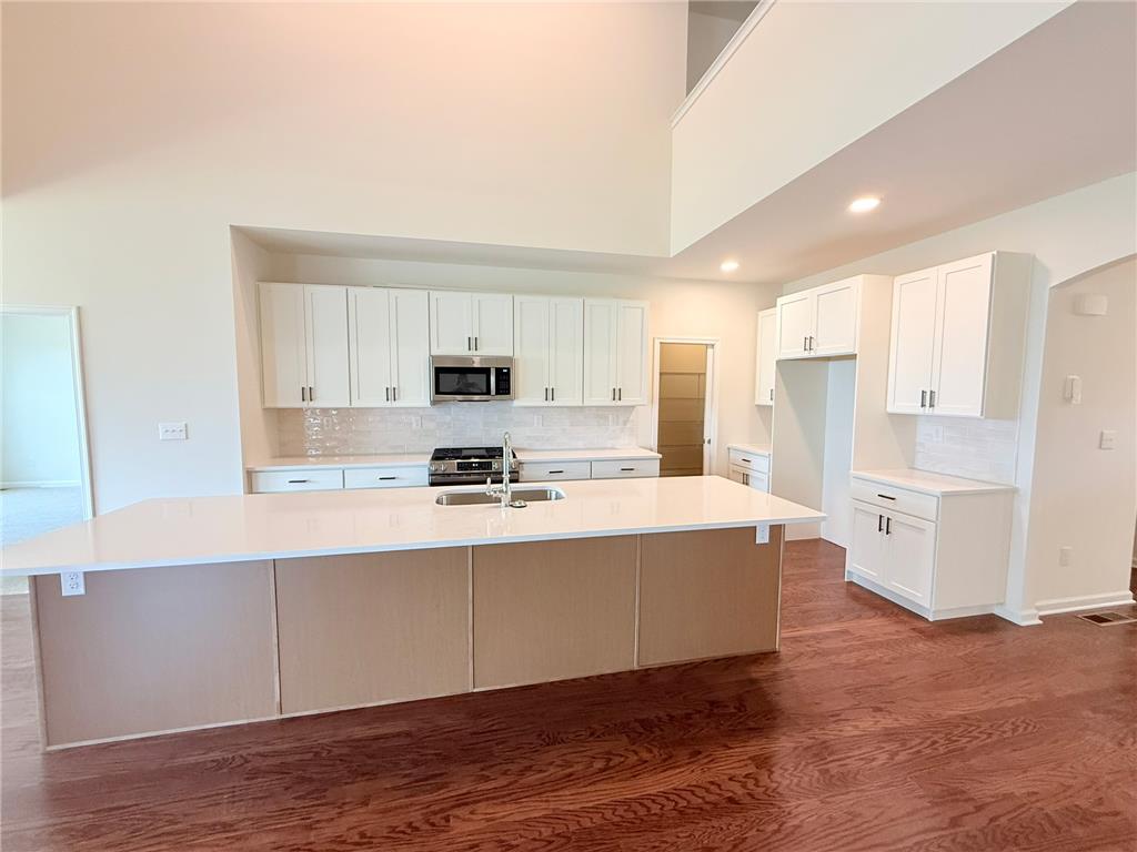 328 Abby Road, Unit LOT 15 Macungie, PA 18062 - Photo 6 of 26 Bright, airy kitchen features hardwood floors, pristine white cabinetry, and an inviting island with a sink.