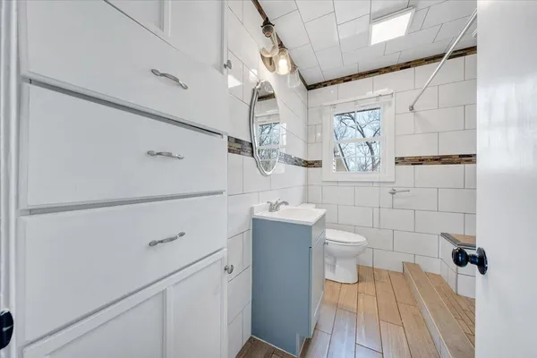 a view of kitchen with refrigerator and window