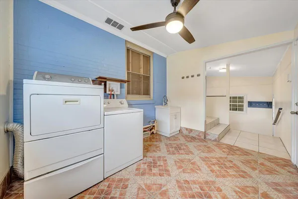 a kitchen with white cabinets a sink stove and a refrigerator