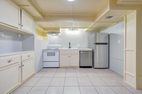 a view of empty room with cabinet and window