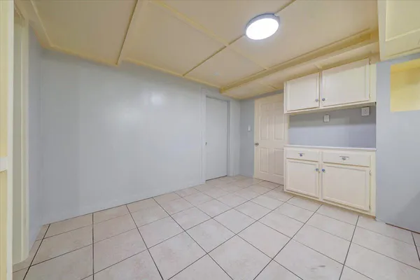 an empty room with a ceiling fan and wooden floor