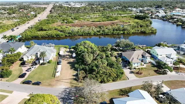 an aerial view of residential houses with outdoor space and lake view