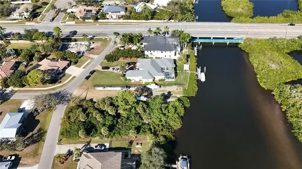 an aerial view of a house with a yard and lake view