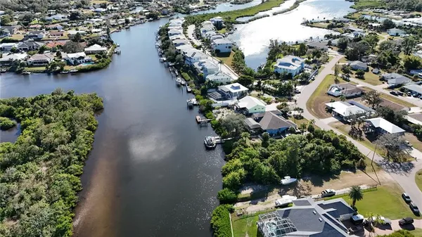 an aerial view of residential houses with outdoor space and lake view