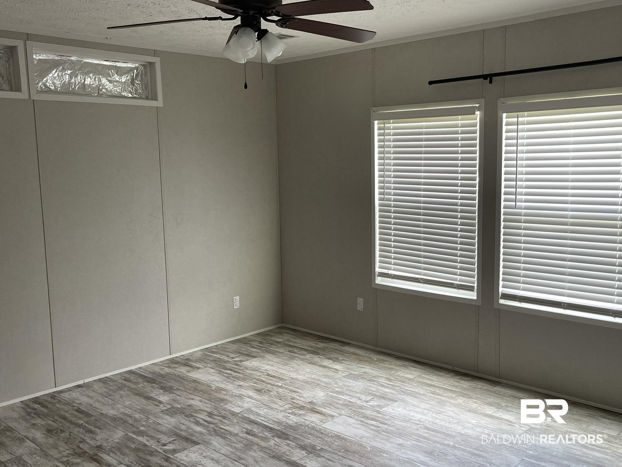 16802 County Road 87 Elberta, AL 36530 - Photo 6 of 19 Unfurnished room with a textured ceiling, ceiling fan, and wood finished floors