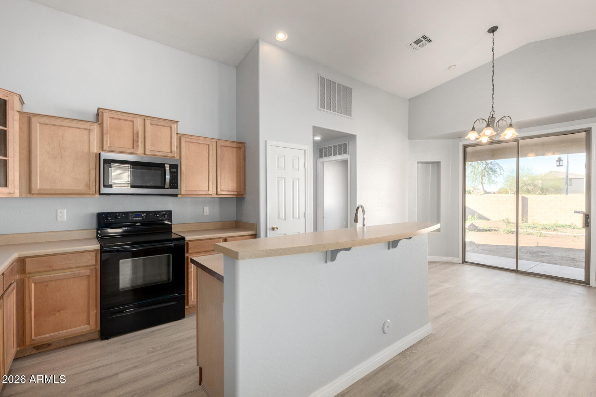 3230 South 74th Lane Phoenix, AZ 85043 - Photo 13 of 57 a kitchen with stainless steel appliances granite countertop a stove a sink and a microwave