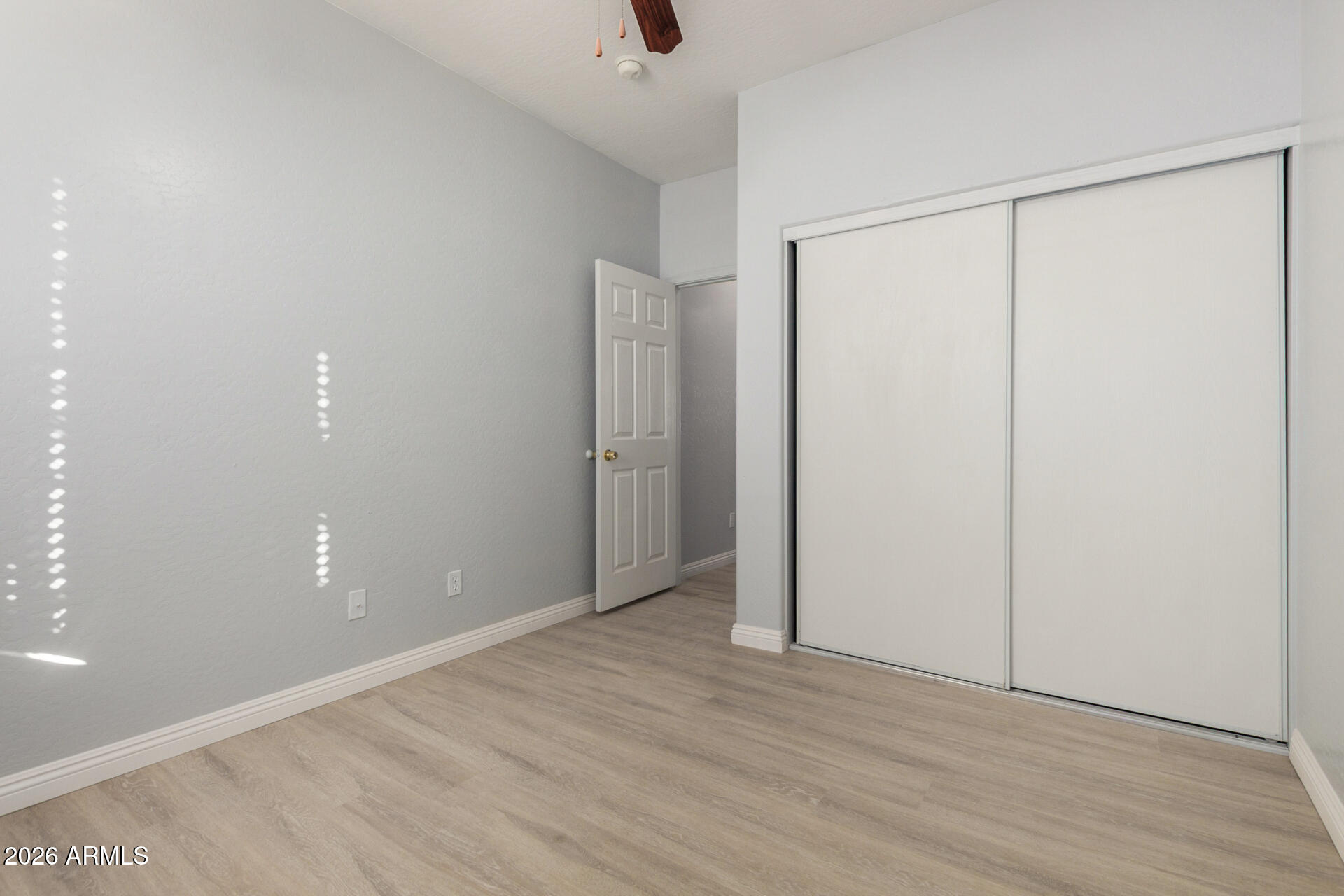 3230 South 74th Lane Phoenix, AZ 85043 - Photo 25 of 57 a view of an empty room with wooden floor