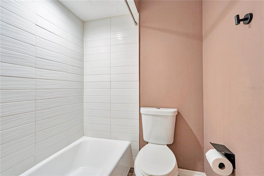 16 Raintree Court Ormond Beach, FL 32174 - Photo 19 of 37 a white toilet sitting next to a bath tub