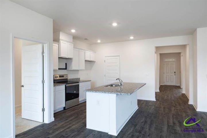 206 Cattle Drive Perry, GA 31069 - Photo 2 of 7 a kitchen with a sink stove and refrigerator