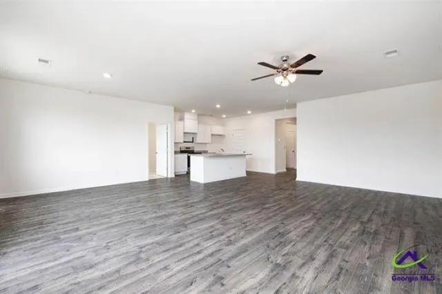 a view of a kitchen with wooden floor and a ceiling fan