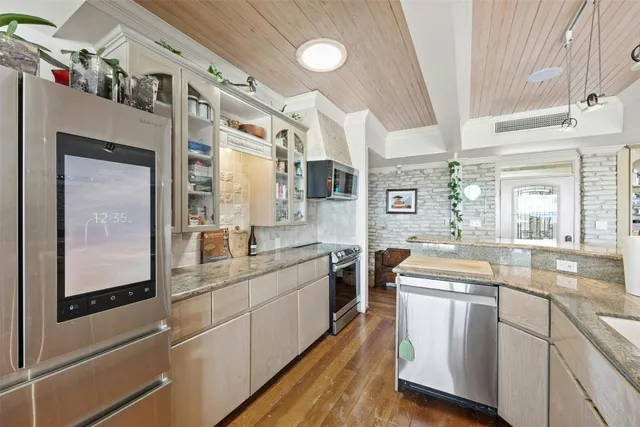 a view of a kitchen with furniture and wooden floor
