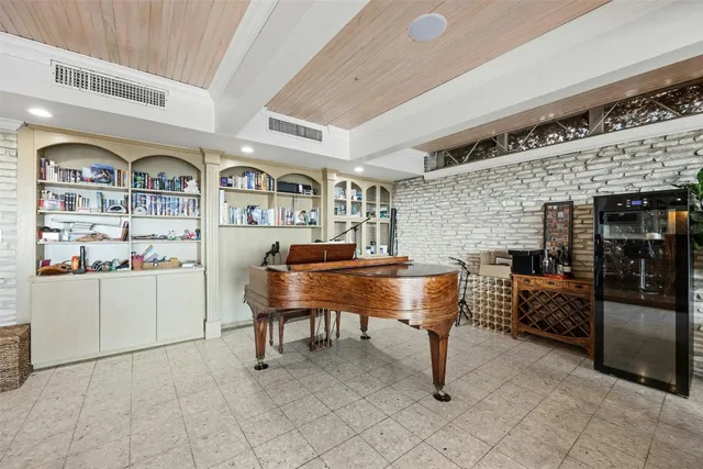 a view of a livingroom with furniture and floor to ceiling window