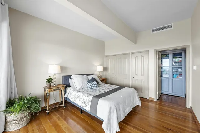 a bedroom with a bed and a large window