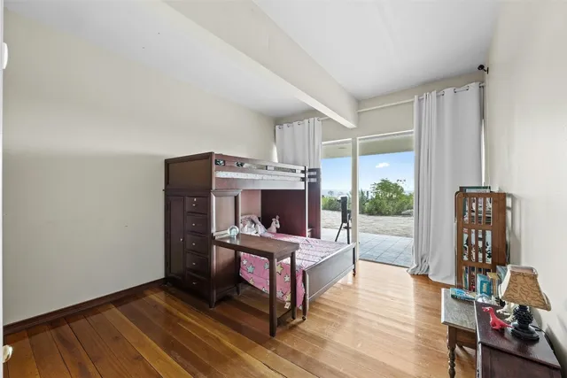 a view of a hallway view with wooden floor and staircase