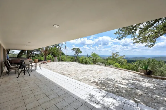 a view of a patio with a table and chairs