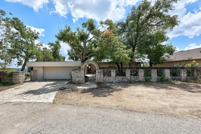 a backyard of a house with table and chairs