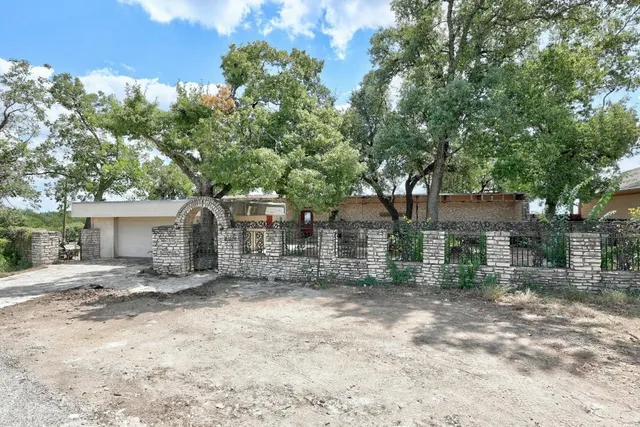 a view of a house with a tree in the background