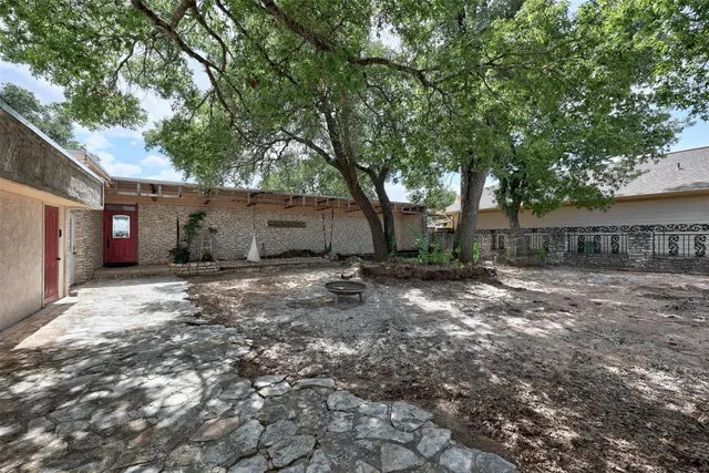a view of a house with a tree in the background