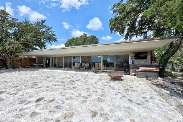 a view of a house with backyard sitting area and porch