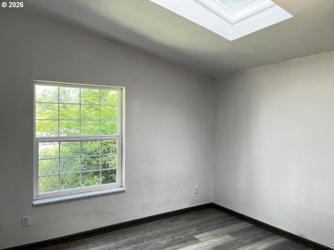 83411 Clear Lake Road Florence, OR 97439 - Photo 35 of 47 an empty room with wooden floor and windows