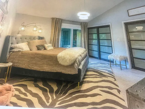 a bedroom with furniture and a mirror