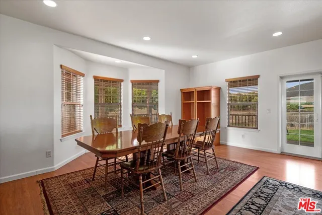 a kitchen with stainless steel appliances granite countertop a sink a stove and refrigerator