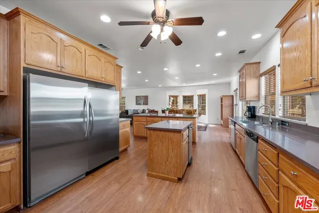 a kitchen with granite countertop a sink a stove and cabinets
