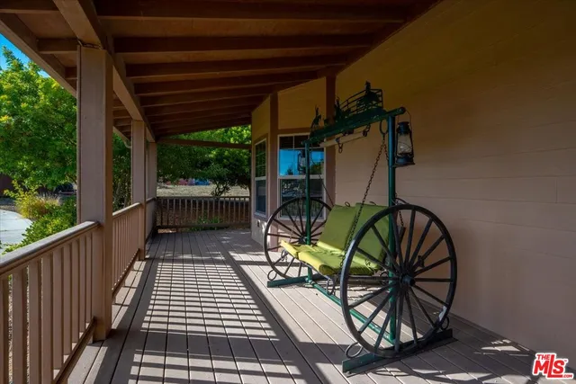 a kitchen with stainless steel appliances granite countertop a refrigerator a sink dishwasher a s stove top oven a dining table and chairs with wooden floor