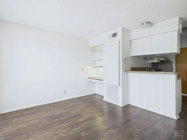 a kitchen with granite countertop a sink and a stove top oven