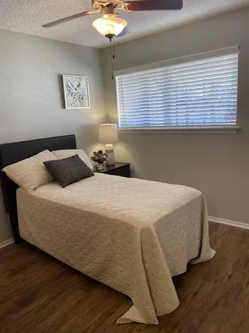 a bedroom with a bed and window