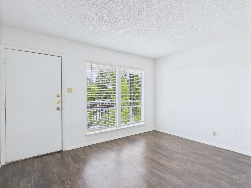 2808 Whitis Avenue, Unit C303 Austin, TX 78705 - Photo 2 of 21 an empty room with wooden floor and windows